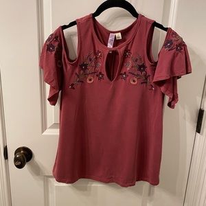 Red blouse with embroidered flowers on breast and sleeves
